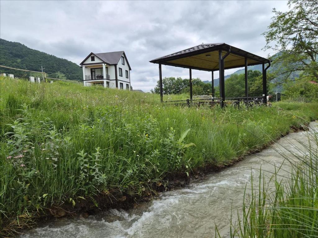 a house sitting on top of a hill next to a river at Quba Garden Resort in Quba