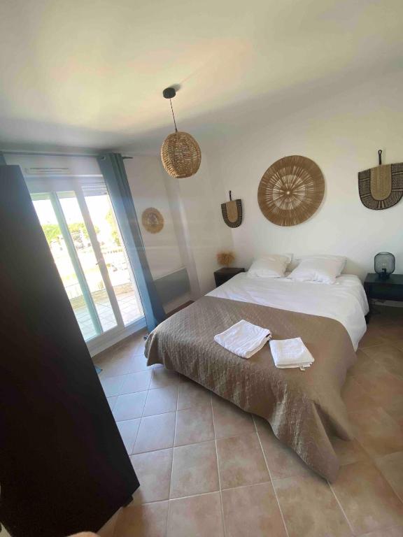 a bedroom with a large bed with towels on it at Spacious 3-room apartment in Fréjus