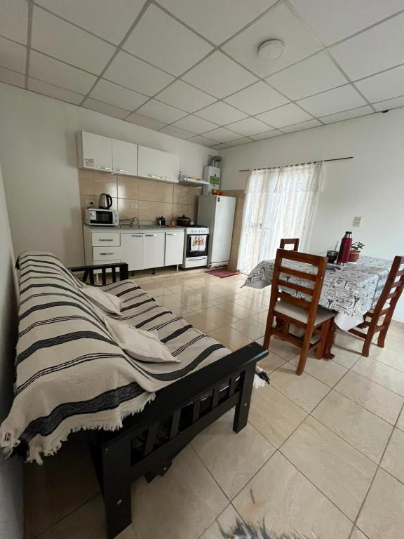 a living room with a bed and a kitchen at Jade in Chajarí