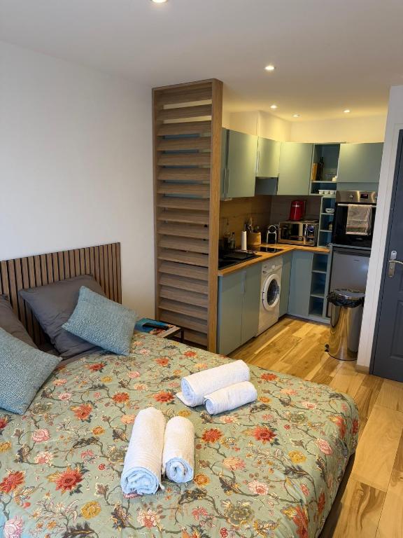 a bedroom with a bed with towels on it at Studio in Cogolin