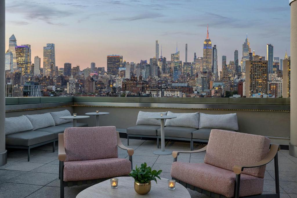 a rooftop bar with a view of a city at Sheraton Tribeca New York Hotel in New York