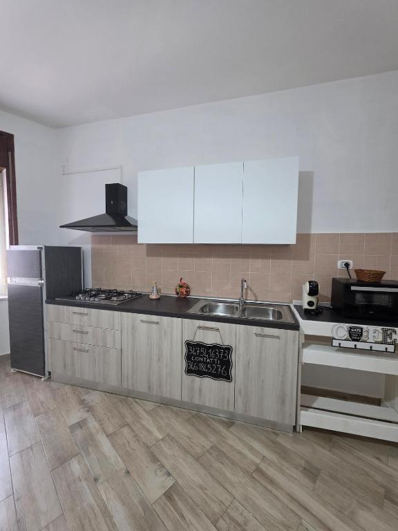 a kitchen with a sink and a stove at Puteoli Stop vacation home in Pozzuoli