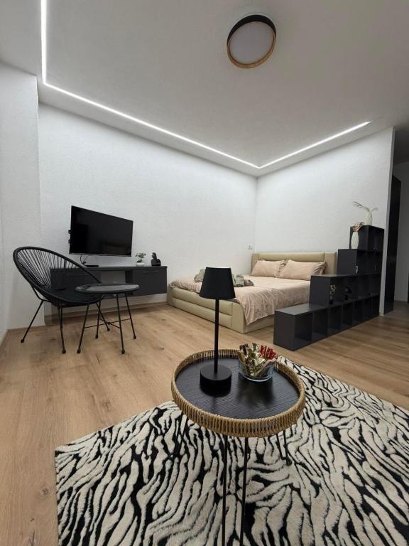 a living room with a bed and a table at IlieskiApartment in Prilep