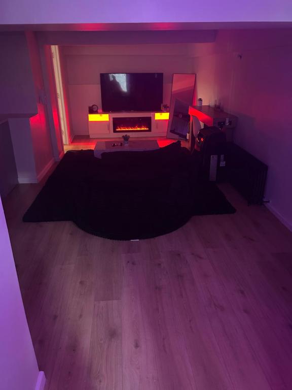 a living room with a flat screen tv and a floor at Private basement apartment with separate entrance in Yonkers