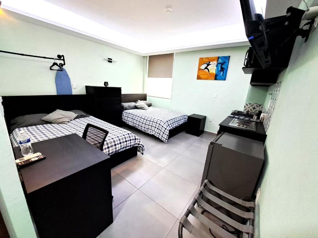 a living room with a bed and a couch at A10 MAX Suite Cocina Terraza Companies Work Teams 2-4 PAX in Cuautitlán Izcalli