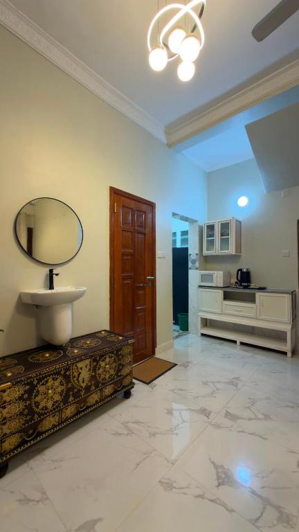 a large room with a sink and a mirror at Shanayah house in Zanzibar City