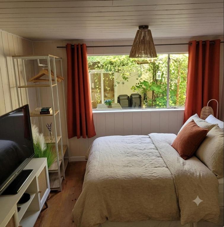 a bedroom with a bed and a window at La Casetta in Gattières