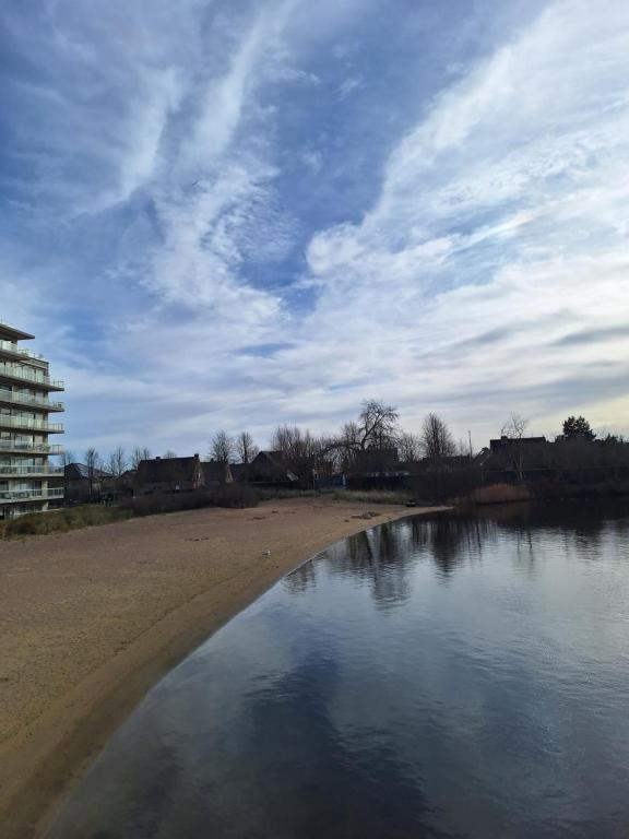 a view of a beach with a cloudy sky at Lagunabeach Knokke-Heist in Knokke-Heist