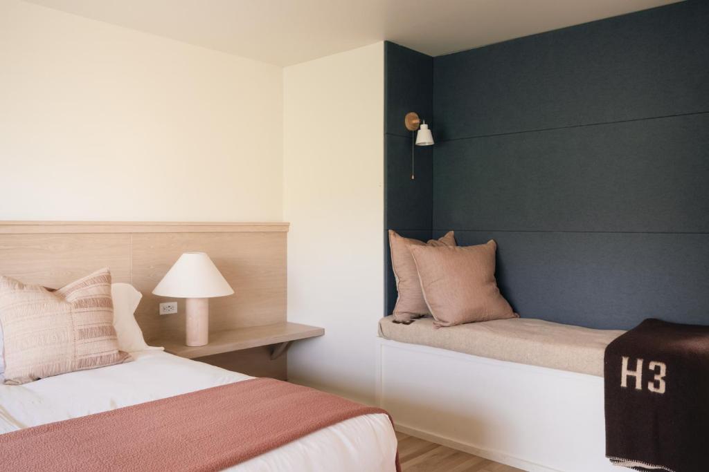 a bedroom with a bed and a wall at Mendocino Cove in Fort Bragg