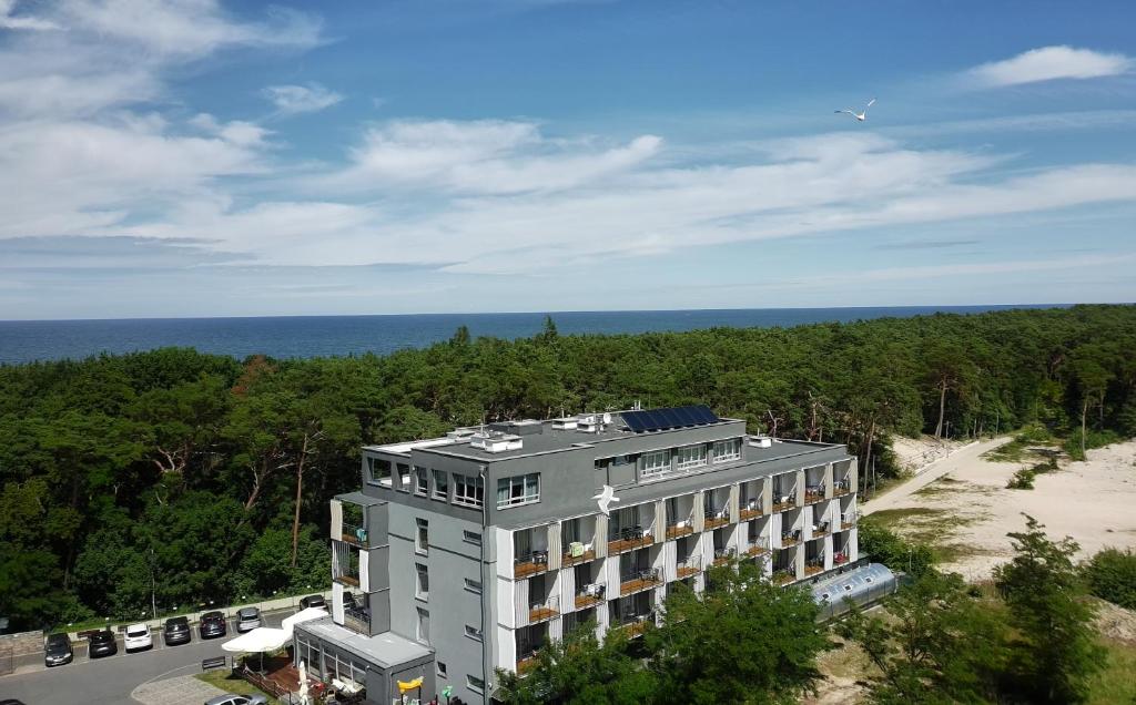 an aerial view of a building with the ocean in the background at WYDMA Resort Medi & SPA - Normobaria in Mrzeżyno
