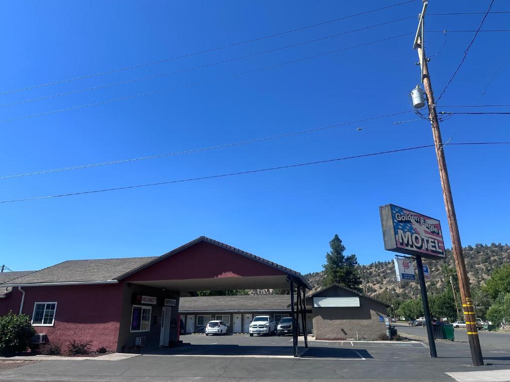 a motel sign in front of a purple building at Golden Eagle Motel in Dorris