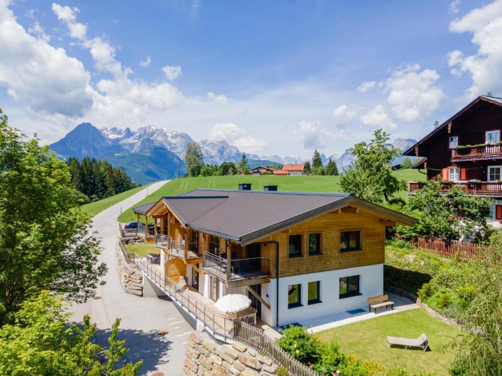 an aerial view of a house with mountains in the background at Adlerblick in Werfenweng