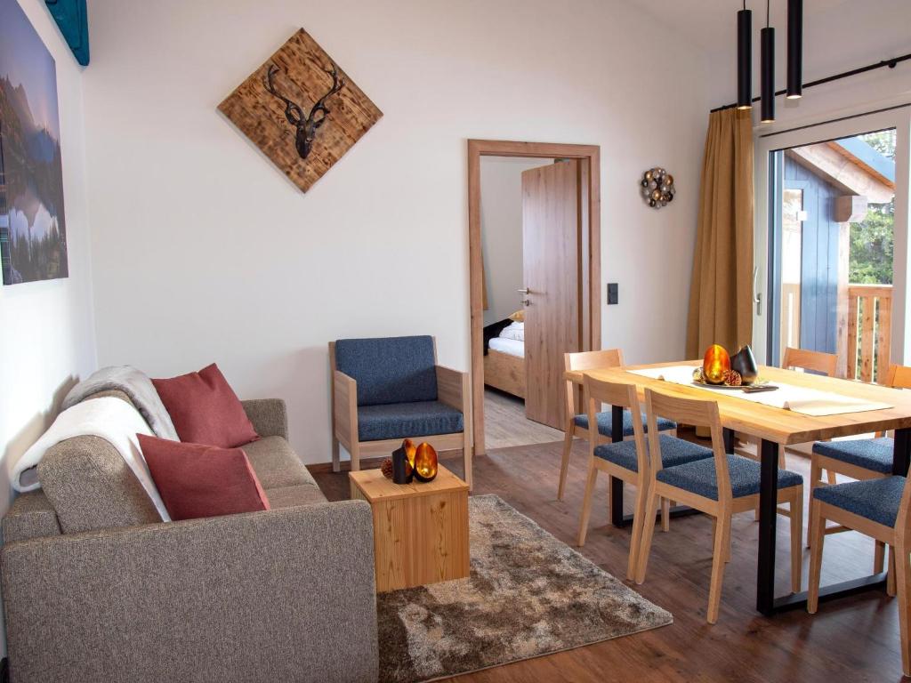 a living room with a table and a dining room at Bockblick Top 4 in Weisspriach