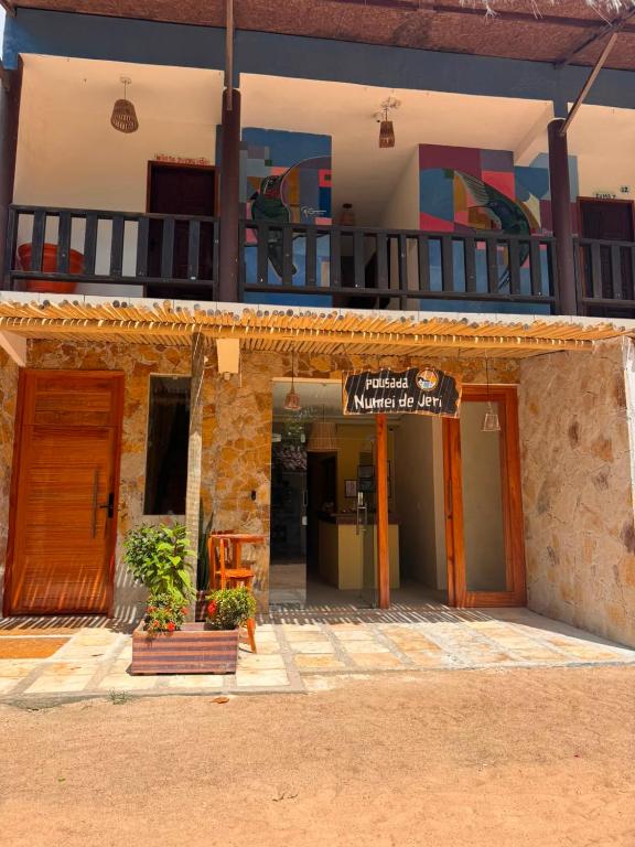 a building with a sign on the side of it at Pousada Numei de Jeri in Jericoacoara