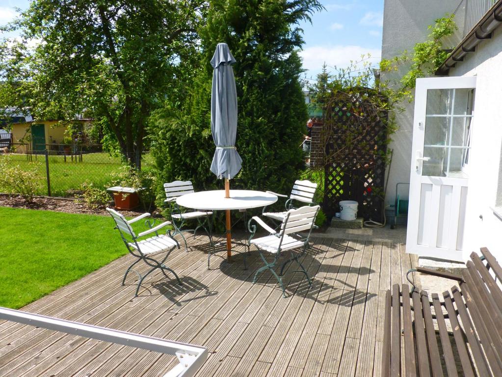 a patio with a table and chairs and an umbrella at Apartament Tuwima 17 in Świnoujście