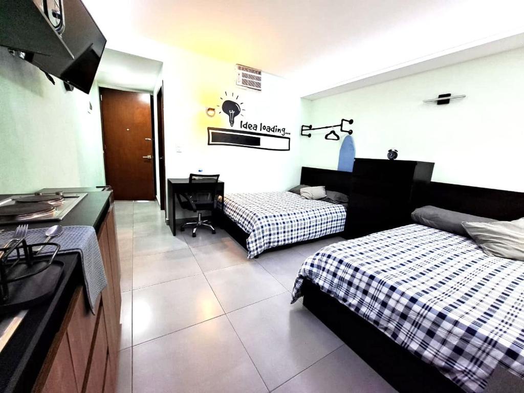 a hotel room with two beds and a desk at A12 MAX Suite Cocina Terraza Empresas Equipos de Trabajo 1-2-3-4 PAX in Cuautitlán Izcalli