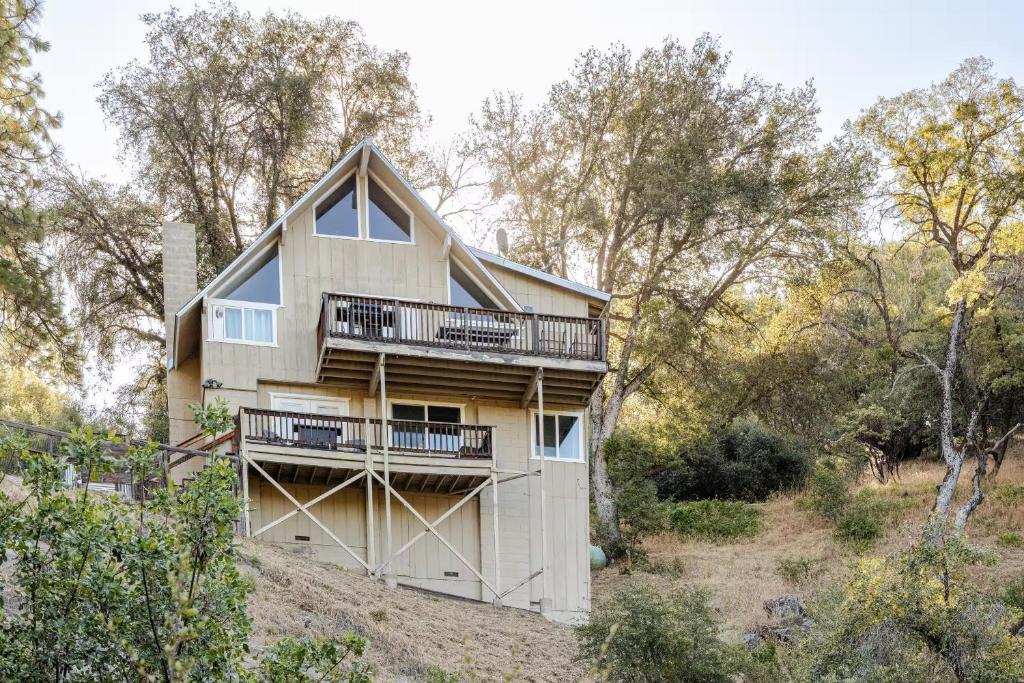 a house on top of a hill with trees at Riverfalls Retreat in Oakhurst