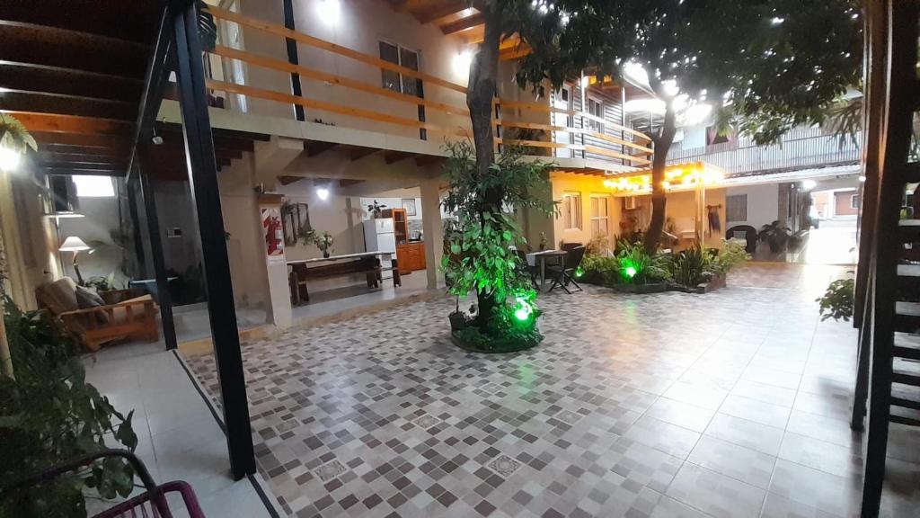 arium of a building with trees and green lights at Alojamiento mei-mei in Puerto Iguazú