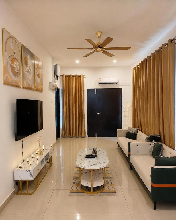 a living room with a couch and a tv at Golden Paradise Fully Aircond in Kuantan
