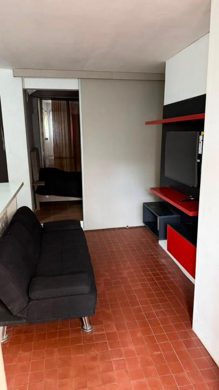 a living room with a couch and a flat screen tv at Casa Thompson in Paraná