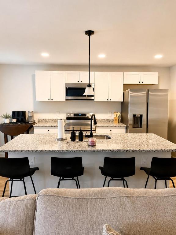 a kitchen with a large island in the middle at Blue Haven Escape in Columbus