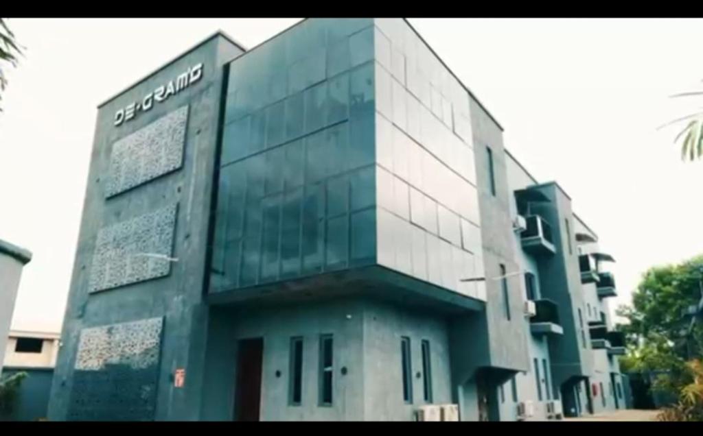 a building with a sign on the side of it at Degrams Hotel and suites in Epe