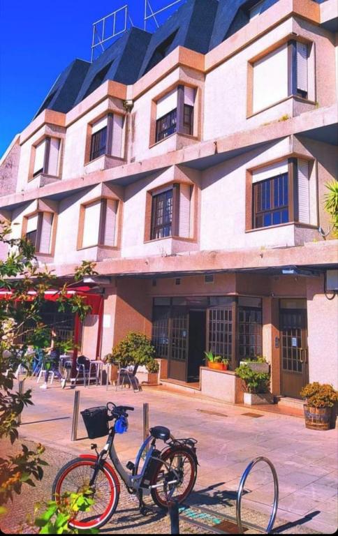 a bike parked in front of a building at Hotel Benalua in Isla de Arosa