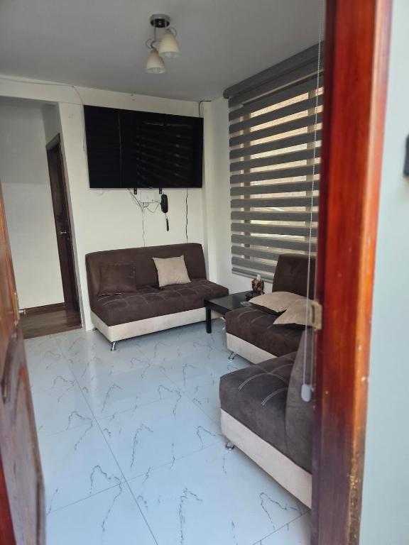 a living room with two couches and a couch at Verona house in Riobamba