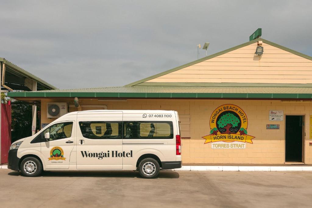 a white van parked in front of a building at Wongai Beach Hotel in Horn