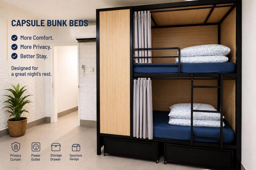 a black bunk bed with blue sheets and pillows at Perth City Backpackers Hostel - note - Valid passport required to check in in Perth