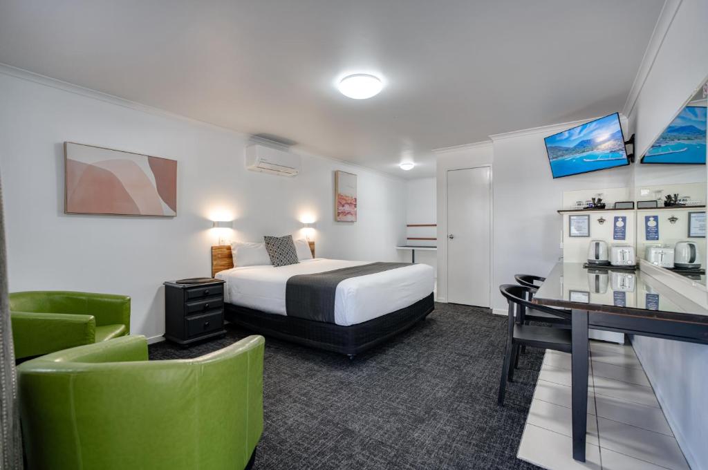 a hotel room with a bed and a desk at Caboolture Gateway Motel in Caboolture