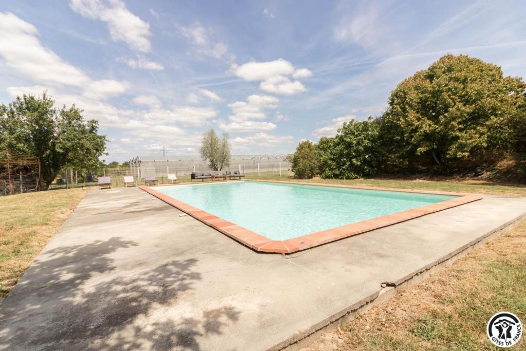 a swimming pool in the middle of a driveway at La busquette in Villaudric