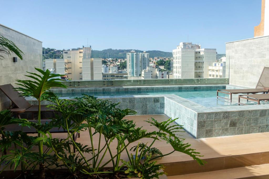 a swimming pool on the roof of a building at Loft Icarai in Niterói