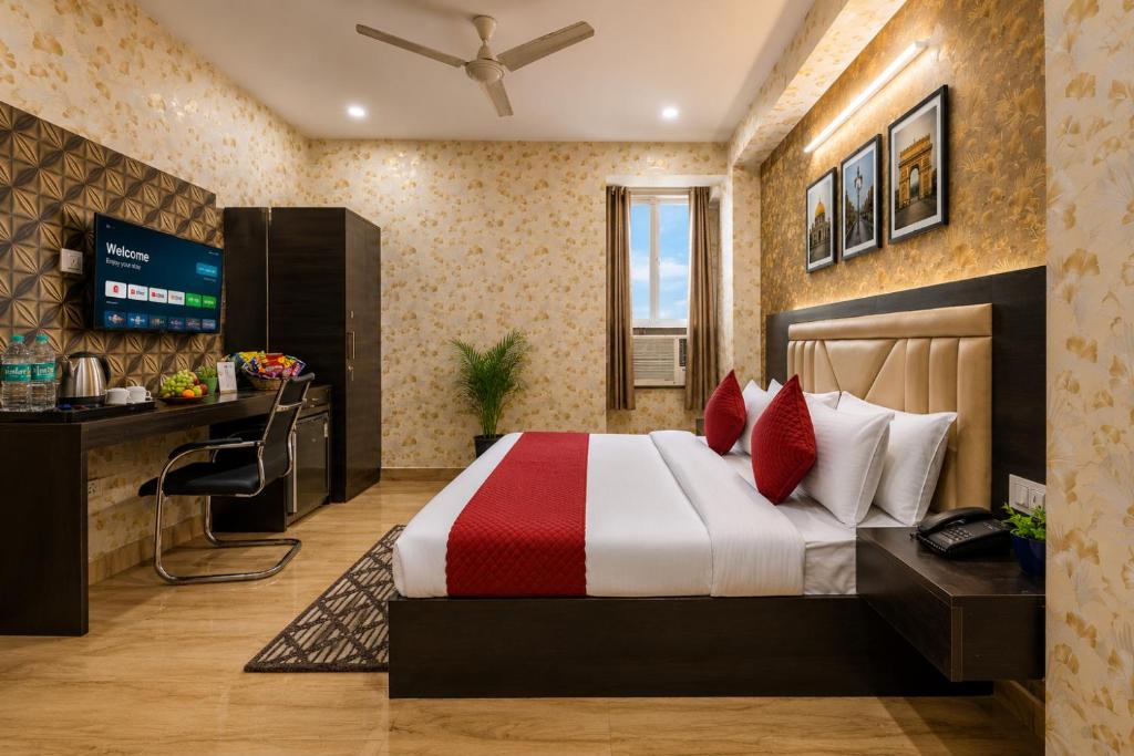 a hotel room with a bed and a television at The Vanta Luxe Near Yashobhumi in New Delhi