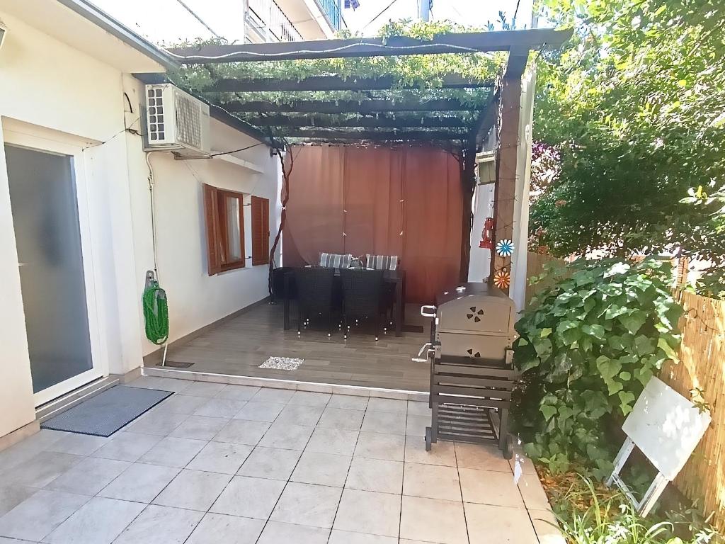 a pergola with a table in the back yard at Apartments Emi & Nini in Šibenik