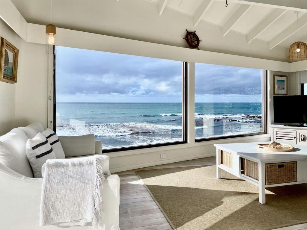 a living room with a large view of the ocean at The Mariner - Oceanfront Living in Falmouth