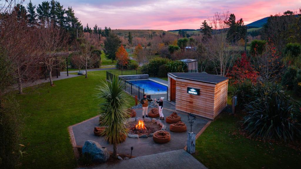 a backyard with a tiny house and a fire pit at Manawa Retreat in Whitecliffs