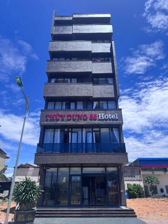 a building with a sign that reads merry driving us hotel at Thuỳ Dung 68 Hotel in Dong Hoi