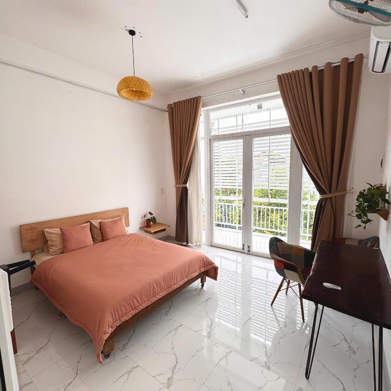 a bedroom with a bed and a piano at Nhà của Buôn in Buon Ma Thuot