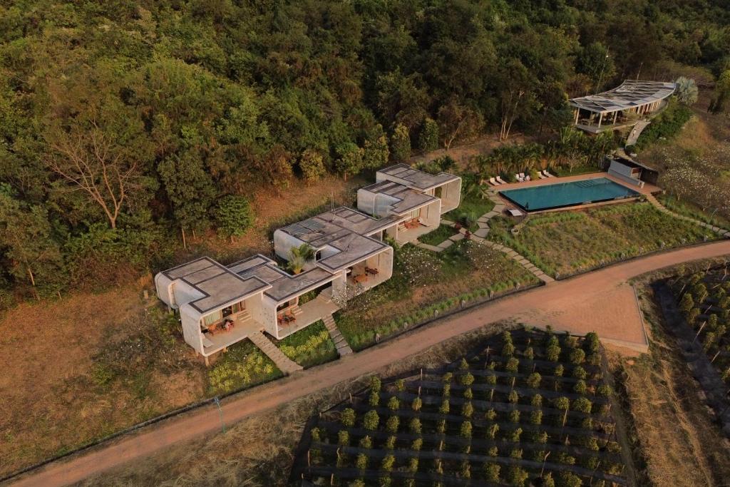 an aerial view of a house with a swimming pool at La Plantation Villa in Kampot