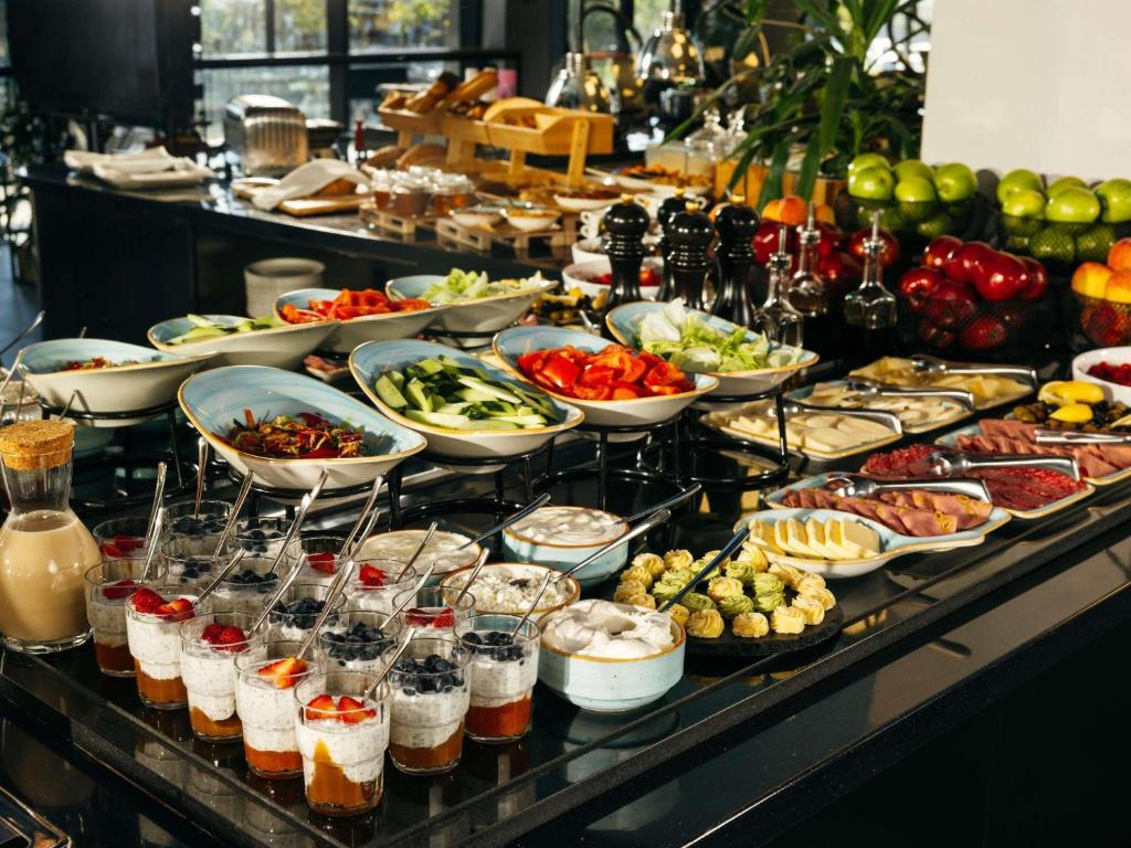 a buffet line with many different types of food at ibis Tbilisi Airport in Tbilisi City