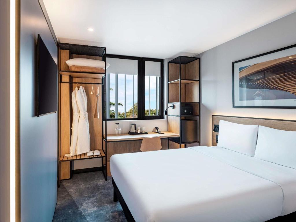 a hotel room with a bed and a sink at ibis Tbilisi Airport in Tbilisi City