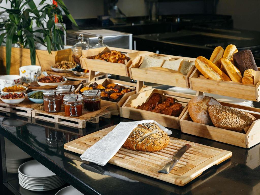 a buffet of bread and pastries on a table at ibis Tbilisi Airport in Tbilisi City