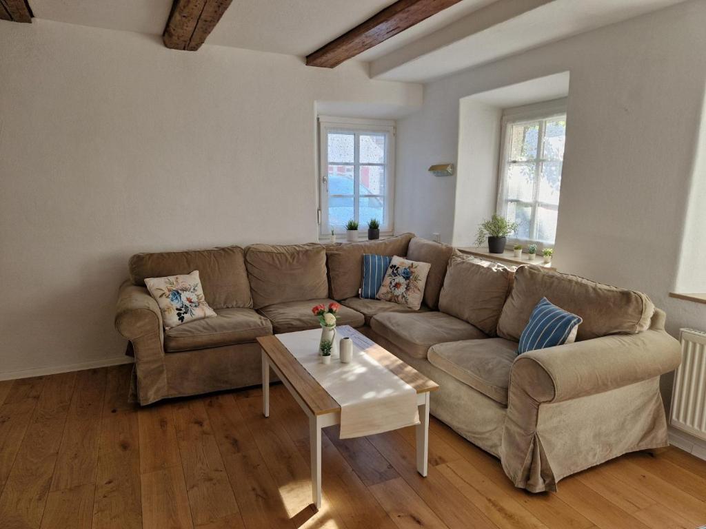 a living room with a couch and a table at Ferienhaus Altstadtgarten in Beilngries