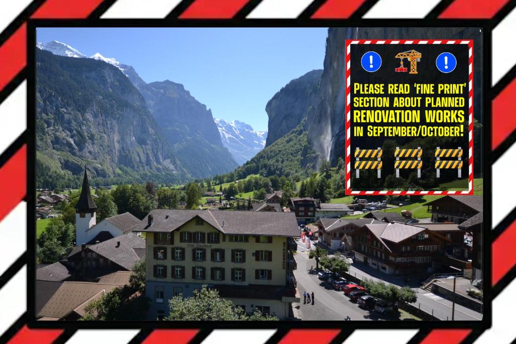 a view from a window of a town in the mountains at Hotel Staubbach in Lauterbrunnen