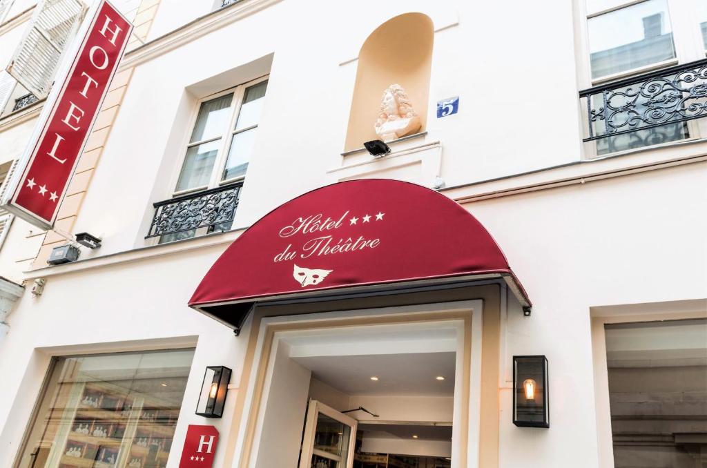 Przednia część sklepu z czerwoną markizą na budynku w obiekcie Hôtel du Théâtre by Patrick Hayat w Paryżu