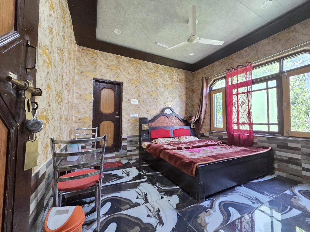 a bedroom with a bed in the corner of a room at Alamdar guest house in Srinagar