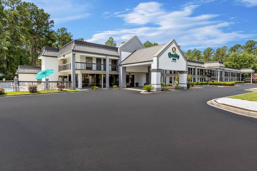 a large white building with a driveway at Quality Inn Walterboro I-95 in Walterboro