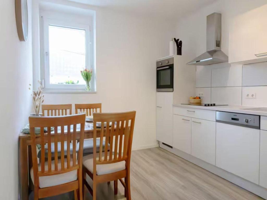 a kitchen with a table and chairs in a room at Ferienwohnung Land Leben in Ziertheim