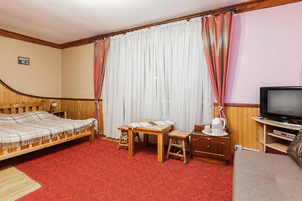 Postel nebo postele na pokoji v ubytování Vatra Hotel